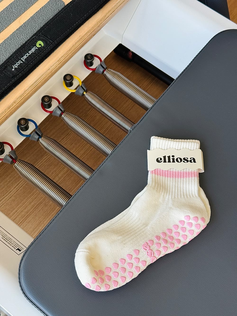 Elliosa grip sock on a Pilates reformer