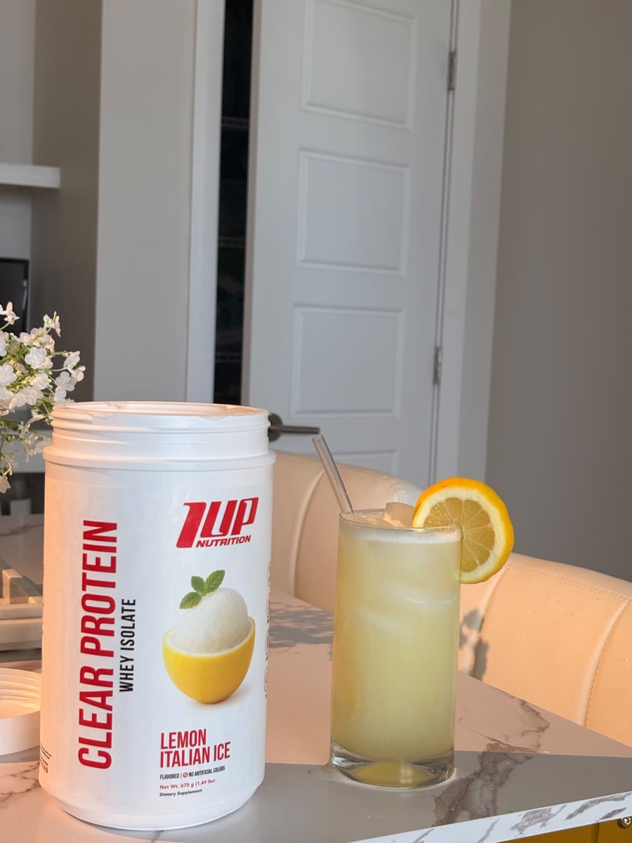 1UP Nutrition Clear Protein tub with a lemon drink