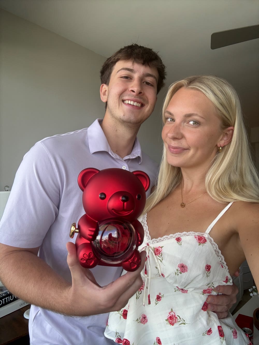 Couple holding a red rose bear gift
