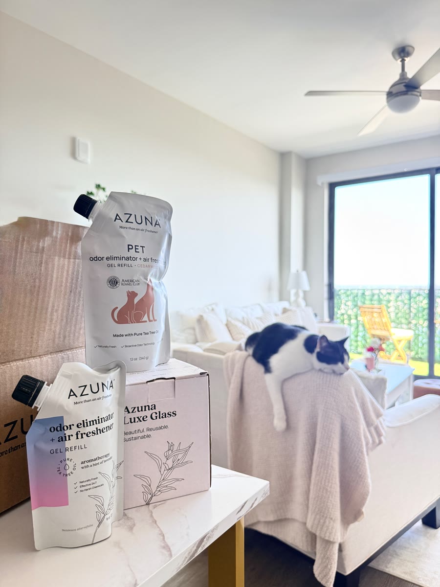Azuna odor eliminator refills with a cat napping on the sofa