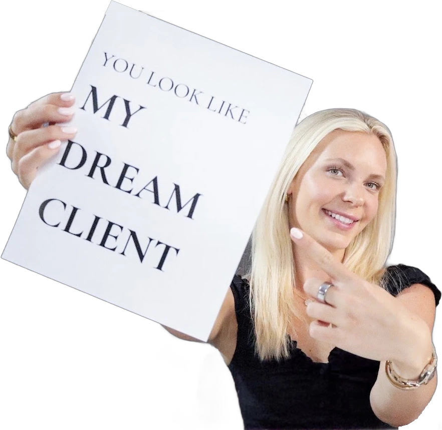 Molly smiling and pointing at a sign that reads You look like my dream client