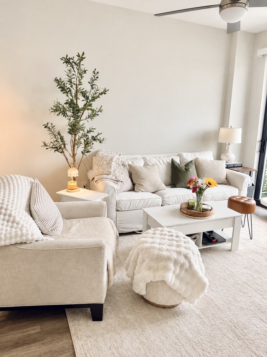 Neutral living room with a cream sofa and olive tree
