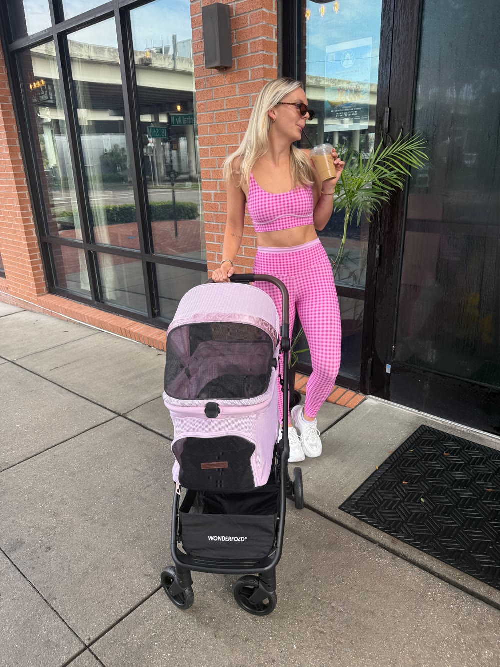 Molly with a pink Wonderfold pet stroller outside a cafe